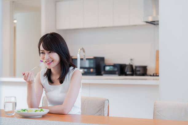 istock Young woman eating Lunch at home 2150450133