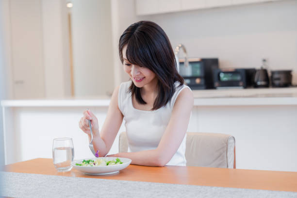 istock Young woman eating Lunch at home 2150450138