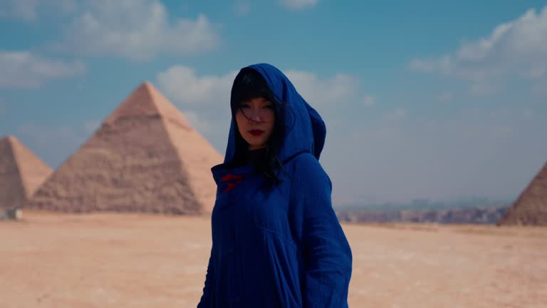 Young Asian tourist posing infront of Pyramids in Giza, Egypt