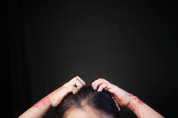 istock kid Scratching her Head against black background 2150451156