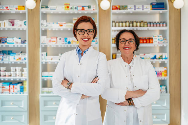 istock Two female pharmacists posing in a drugstore. 2150451296