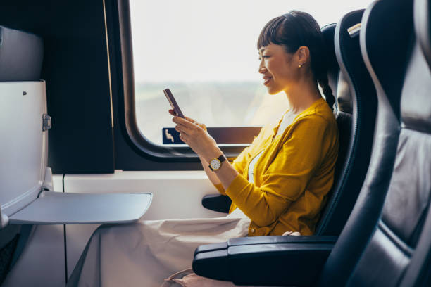 istock Asian Businesswoman Using Smartphone on Train Journey 2150451569