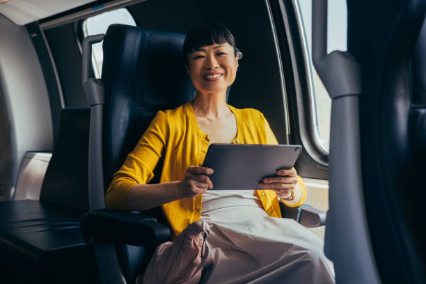 istock Confident Businesswoman Working on Tablet in Airplane 2150451586