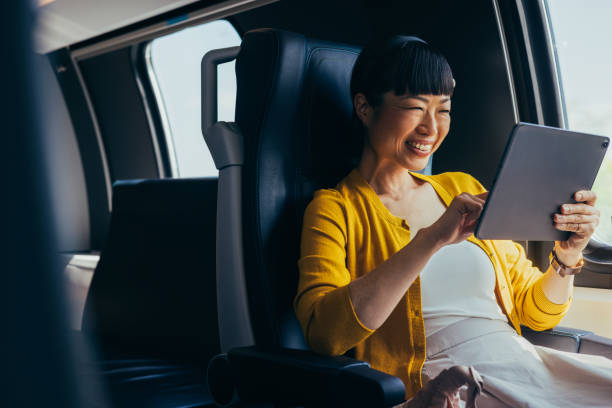 istock Joyful Businesswoman Using Tablet in Comfortable Car Seat 2150451601
