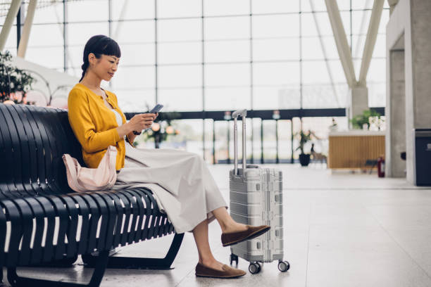 Elegant Woman Using Smartphone at Modern Airport Lounge