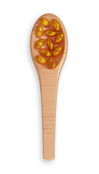 istock Pills on wooden spoon on white background 2150452727