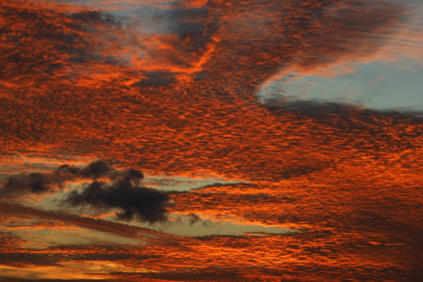 Albion, Mauritius - April 27, 2024: Vibrant colors during sunset at the Indian Ocean close the public beach of Albion in the West of Mauritius. Some clouds make the scenery more spectaculor.