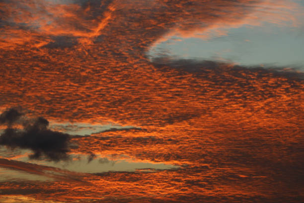 Albion, Mauritius - April 27, 2024: Vibrant colors during sunset at the Indian Ocean close the public beach of Albion in the West of Mauritius. Some clouds make the scenery more spectaculor.