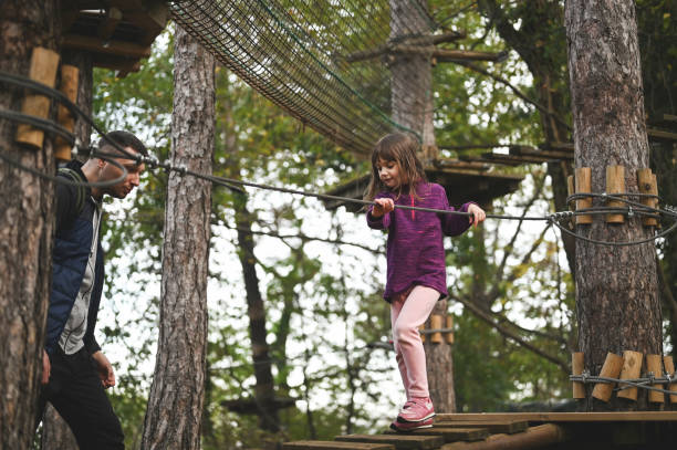istock Family walking on a rope play structure. 2150456823