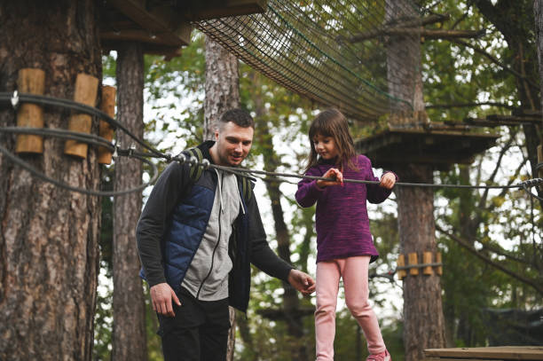istock Family climbing in adventure park. 2150456837