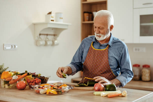 istock Happy Retired Senior Man Cooking in Kitchen 2150457263