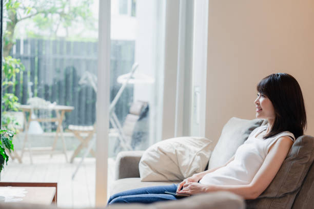 istock Young woman watching TV at home 2150457791