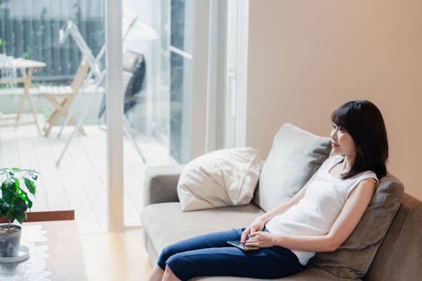 istock Young woman watching TV at home 2150457795