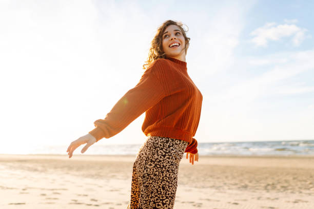 istock Beautiful woman walking at a beach at sunset. 2150458121