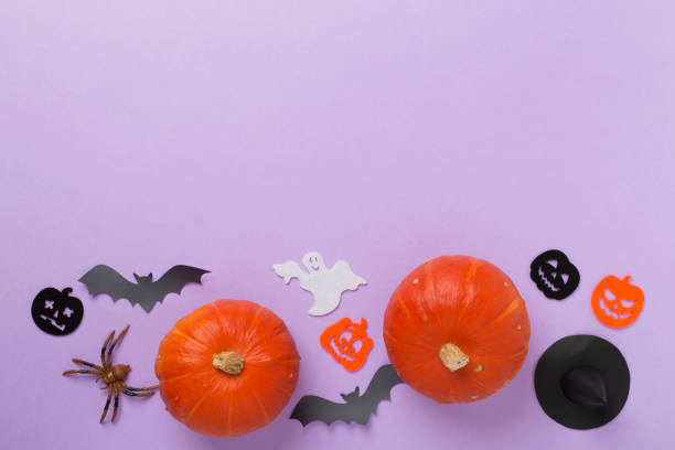 istock Halloween decoration and pumpkins on color background, top view 2150458287