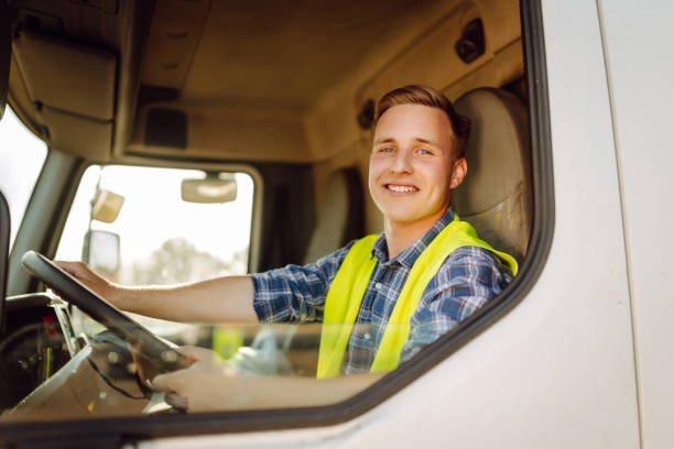 istock Handsome driver at the wheel of a truck at work. 2150459214
