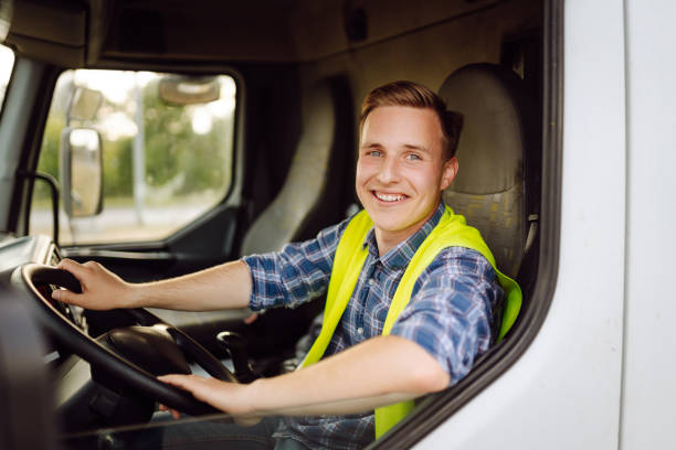 istock Handsome driver at the wheel of a truck at work. 2150459232
