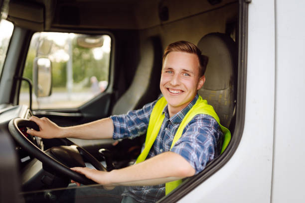 istock Handsome driver at the wheel of a truck at work. 2150459233