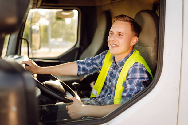 istock Handsome driver at the wheel of a truck at work. 2150459247