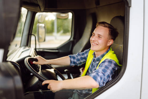 istock Handsome driver at the wheel of a truck at work. 2150459251