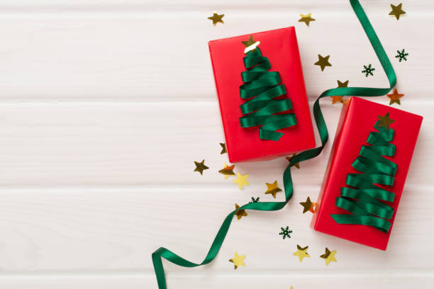 istock Creative handmade christmas gift boxes with decor on wooden background, top view 2150459301