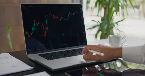 istock Man Checking His Stock Market Exchange Investment Using His Laptop Compute 2150459342