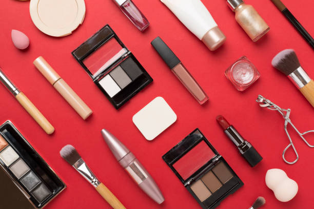 istock Flat lay with makeup products and tools on color background 2150459598