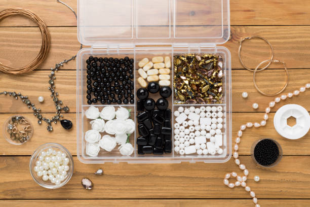 istock Tools and beads for making handmade jewelry on wooden background, top view 2150461439