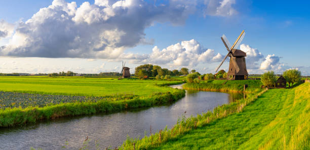 istock Dutch Windmills along a Canal near Schermerhorn, Netherlands 2150463452