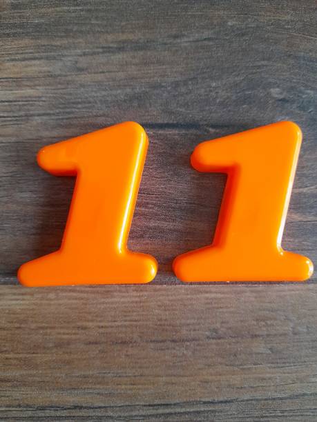 istock Number 11 with wooden background 2150463598