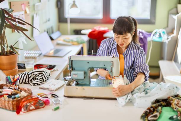 istock Woman making clothes at home 2150463844