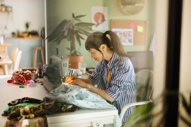 istock Woman patching her clothes at home 2150463880