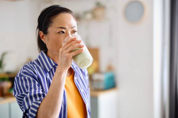 istock Relaxed woman drinking matcha at home 2150464182