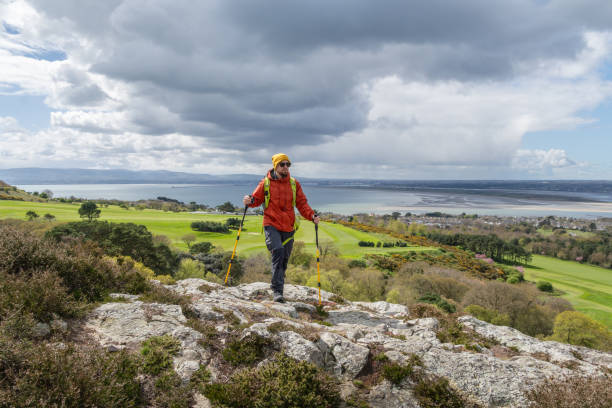 istock Hiker reaching top of mountain 2150464332