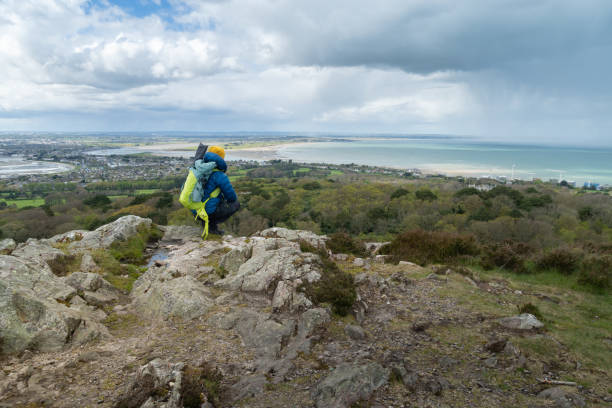 istock Hiker resting on hill admiring Howth Bay. 2150464359