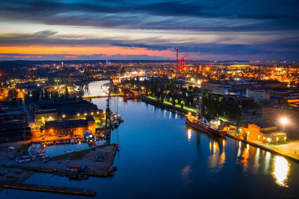 istock Industrial port at twilight with illuminated cityscape 2150470251