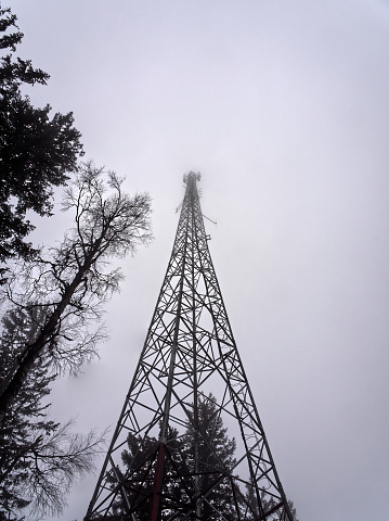 Low angle view of radio tower lost in fog