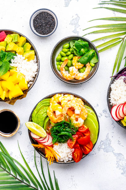 istock Poke bowls with vegetables and seafood set for balanced diet, white table background, top view 2150471402
