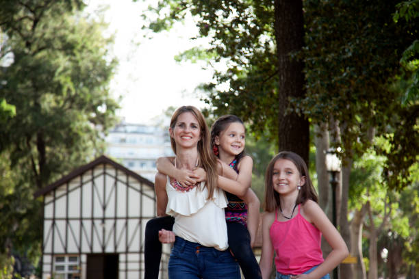 istock Happy mother and daughters having fun outdoors 2150472039