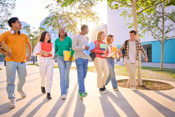 istock Happy international students walking around the university campus. Young multicultural friends 2150478517