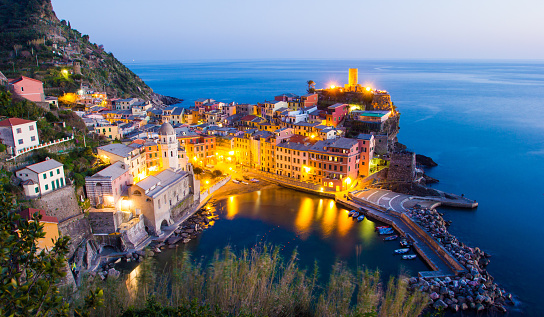 Elevated view of vernazza in cinque terre, italy, lit up during the blue hour