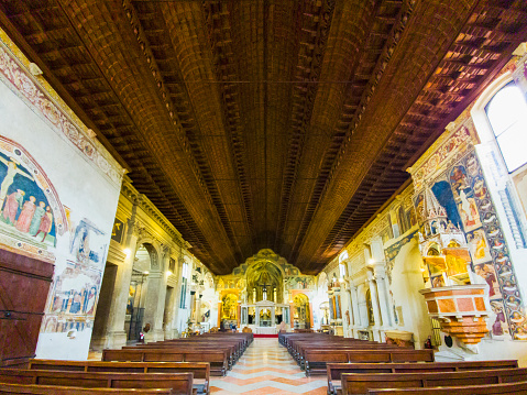 Nave of San Zeno church in Verona showing ornate paintings and carvings