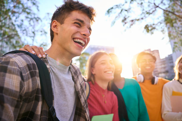 Happy young multiracial university students posing together taking a photo