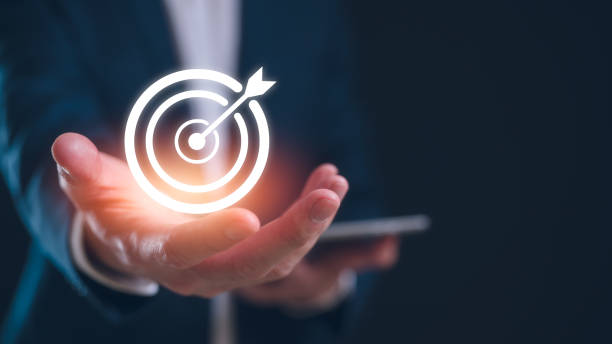istock Hand holding virtual target board and arrow. Business achievement goal and objective target concept 2150481935
