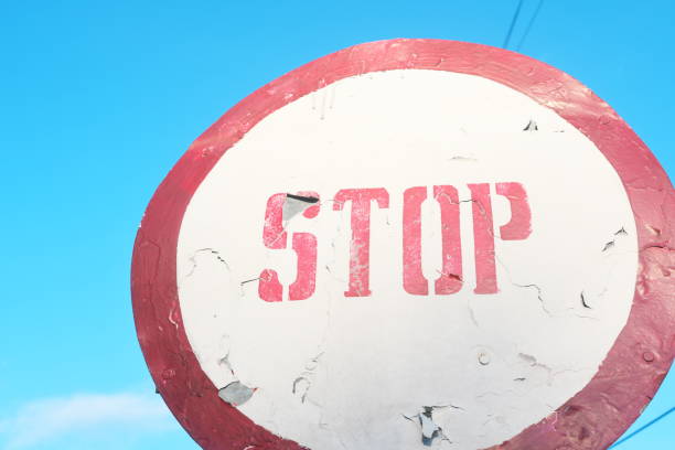 istock Circular red stop sign road warning against clear blue sky. 2150483911