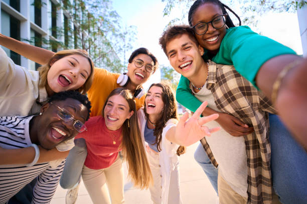 istock A large multiracial group of teenagers taking a selfie looking front camera laughing 2150487894