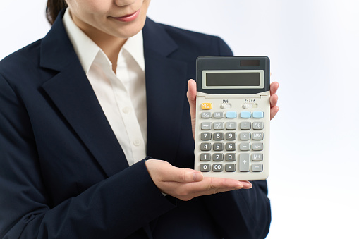 Business woman showing a calculator