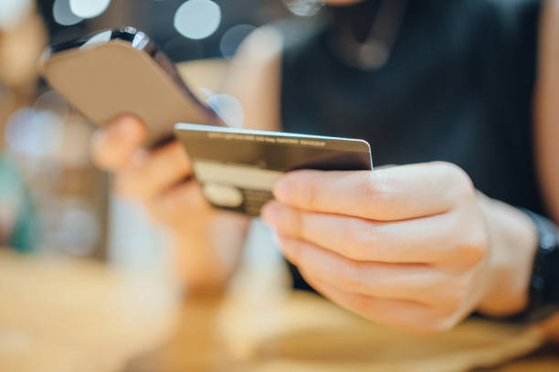 istock Close-up hands using smart devices for personal financial management 2150490864