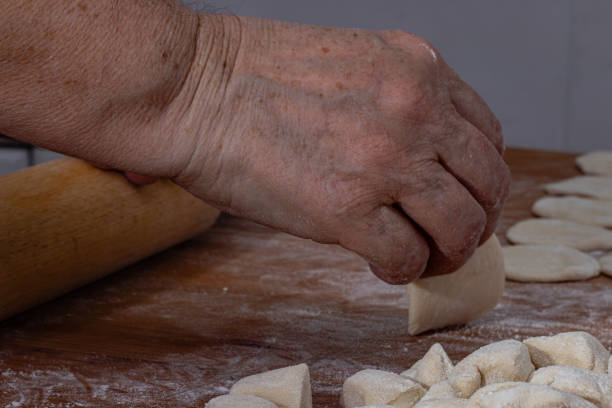 istock A woman rolls dumplings for dumplings. 2150490885