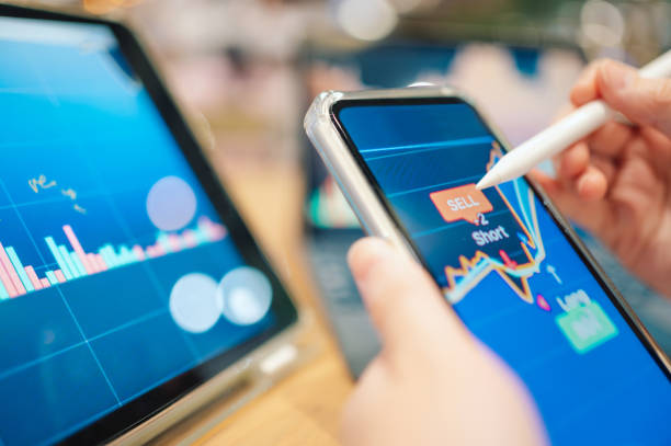 istock Close-up hands using smart devices for personal financial management 2150491170